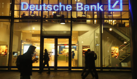 BERLIN, GERMANY - FEBRUARY 09: People walk past a branch of Deutsche Bank on February 9, 2016 in Berlin, Germany. Shares of Deutsche Bank rose 16% on the Frankfurt stock exchange on February 10 following rumours the bank may announce a bond buy-back initiative. (Photo by Sean Gallup/Getty Images)